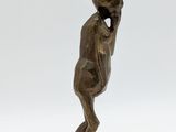 bronze statue of a man with a hat on his head