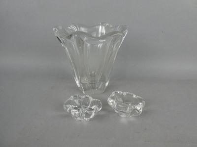 a glass vase with three pieces of glass on the table