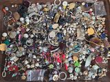 a tray full of assorted jewelry on a table