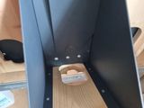 a close up of a piece of wood with a metal holder