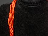 a close up of a necklace on a mannequin display