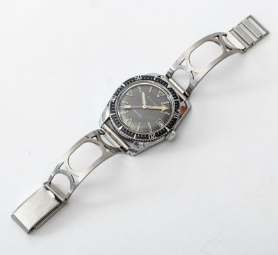 an image of a watch on a bracelet on a white surface