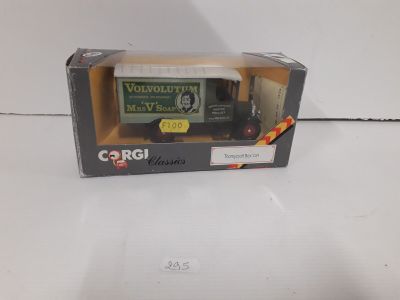 a box with a toy truck in it on a white surface