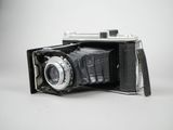 a black and white photo of an old camera on a table