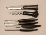 several knives are lined up in a row on a table