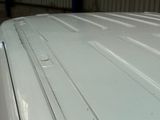 a close up of a white car with a lot of scratches on it