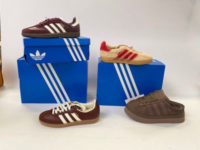 three pairs of shoes sitting on top of a blue box