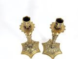 pair of antique brass candlesticks on a white background