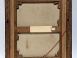 an old picture of a wooden frame with a piece of paper attached to it