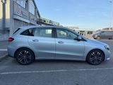 a silver mercedes b - class parked in a parking lot