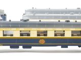 several blue and yellow train cars are lined up on a white surface