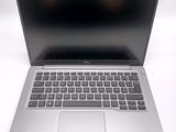 an open laptop computer sitting on top of a white table