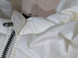 a close up of a white jacket with a zipper on it
