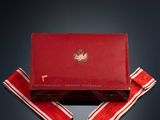 an image of a red box with a red ribbon and a pair of scissors