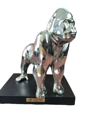 statue of a silver dog on a black base