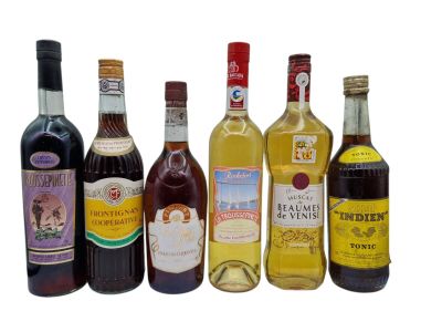 several bottles of wine are lined up on a white surface