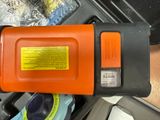 an orange and black tool sitting on top of a table