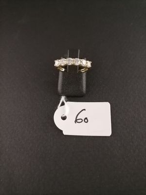 a diamond ring with a price tag on a black surface