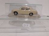 a small model of a car in a glass case