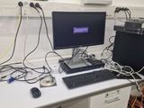 a desk with a computer and a keyboard on it