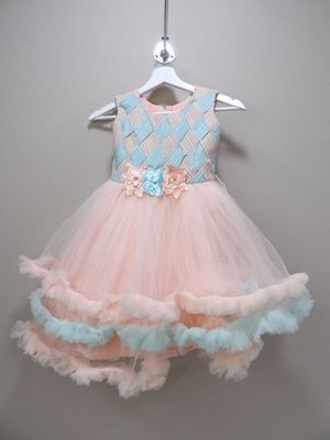 pink and blue dress hanging on a hanger on a wall