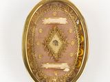 a picture of a gold locke with a picture of a woman on it
