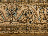 an antique persian rug with a floral design on a brown ground