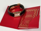 a red book with a gold watch on it and a red book with a gold watch on it