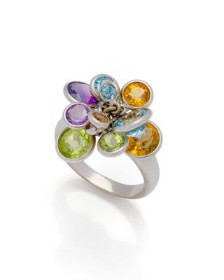 un gros plan d'une bague en argent sertie de pierres multicolores