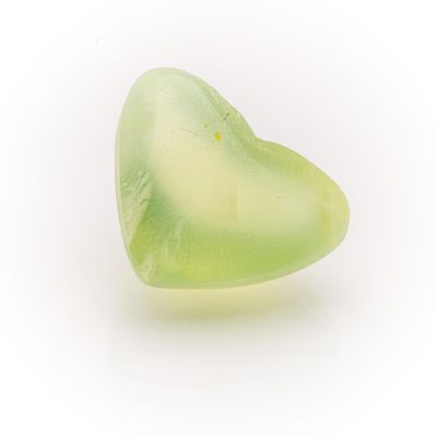 a green heart shaped piece of glass on a white surface