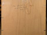 an old wooden box with writing on it sitting in a room