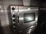 a stainless steel oven sitting on a counter in a kitchen