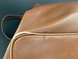 the inside of a tan leather bag with a zipper