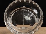 a glass bowl with a clock inside of it on a table