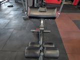 a gym room with a row of exercise equipment in it