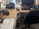 a desk with a computer and a phone on it