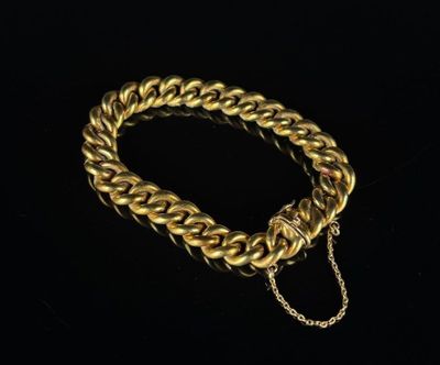a gold chain bracelet with a clasp on a black background