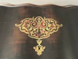 a black table with a gold and red design on it