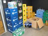several boxes of soda are stacked on top of each other in a room
