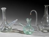 three glass vases that are sitting on a table