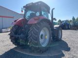 a picture of a red tractor parked in a parking lot