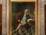 painting of a man sitting in a chair in front of a painting