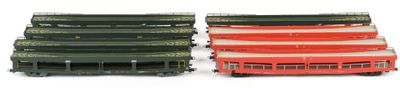 two red and green buses next to each other on a white surface