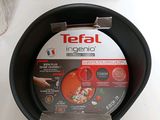 a black pan with a lid sitting on a table next to a box