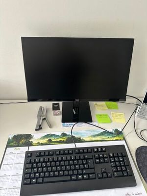 a keyboard, mouse, and monitor on a desk