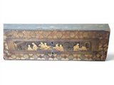 an old wooden box with gold and black designs on it