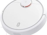 une image représentant un robot aspirateur sur fond blanc