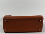 a brown leather case with two handles on a white background