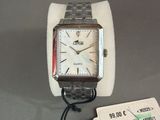 someone is holding a watch on a wrist with a price tag