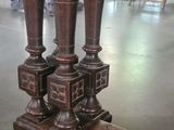 a close up of a wooden table with two vases on top of it
